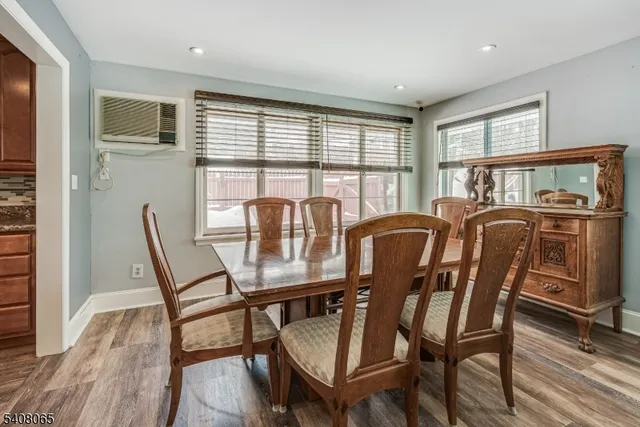 a view of a dining room with furniture large window and wooden floor