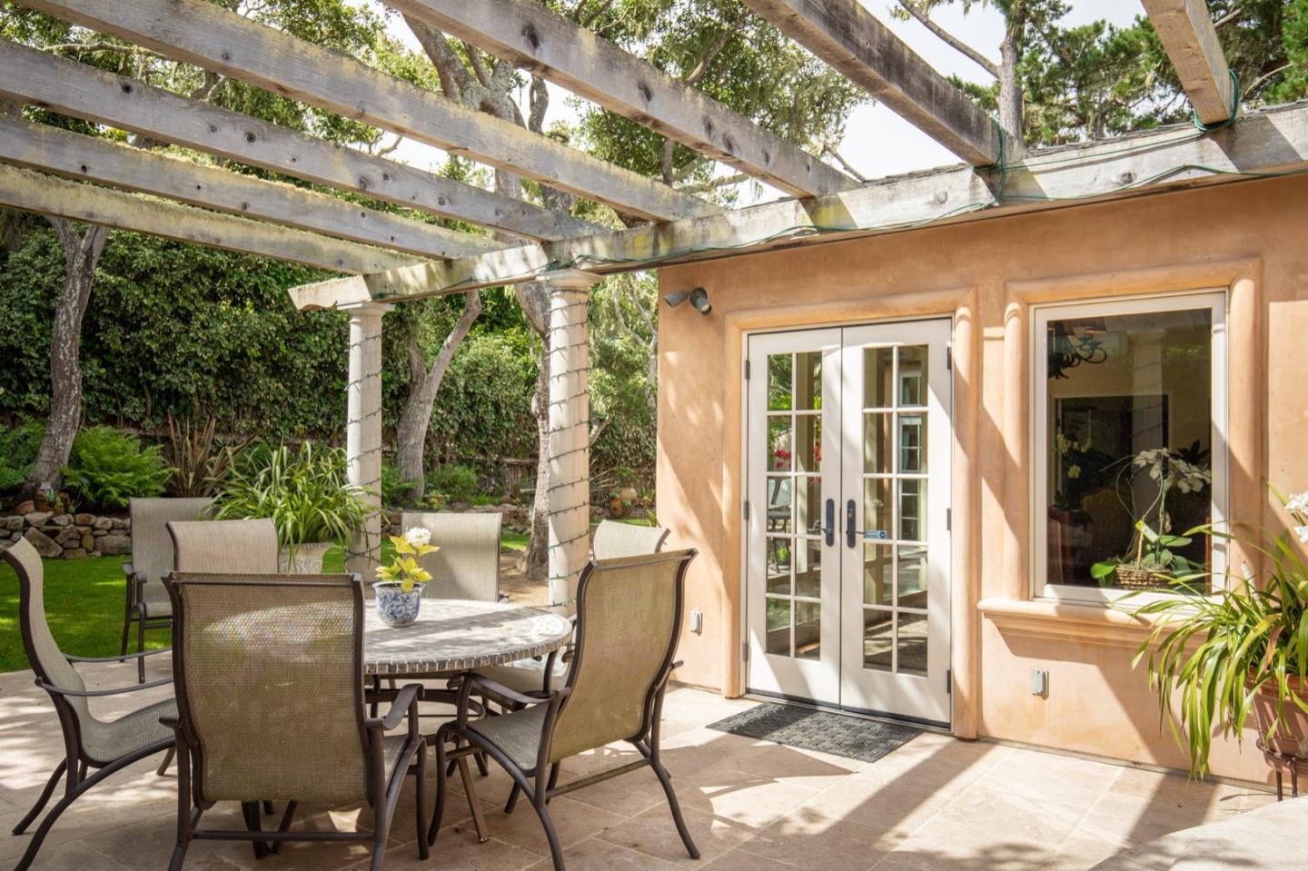 2869 Coyote Road Pebble Beach, CA 93953 - Photo 11 of 35 a view of an outdoor dining space with a table and chairs