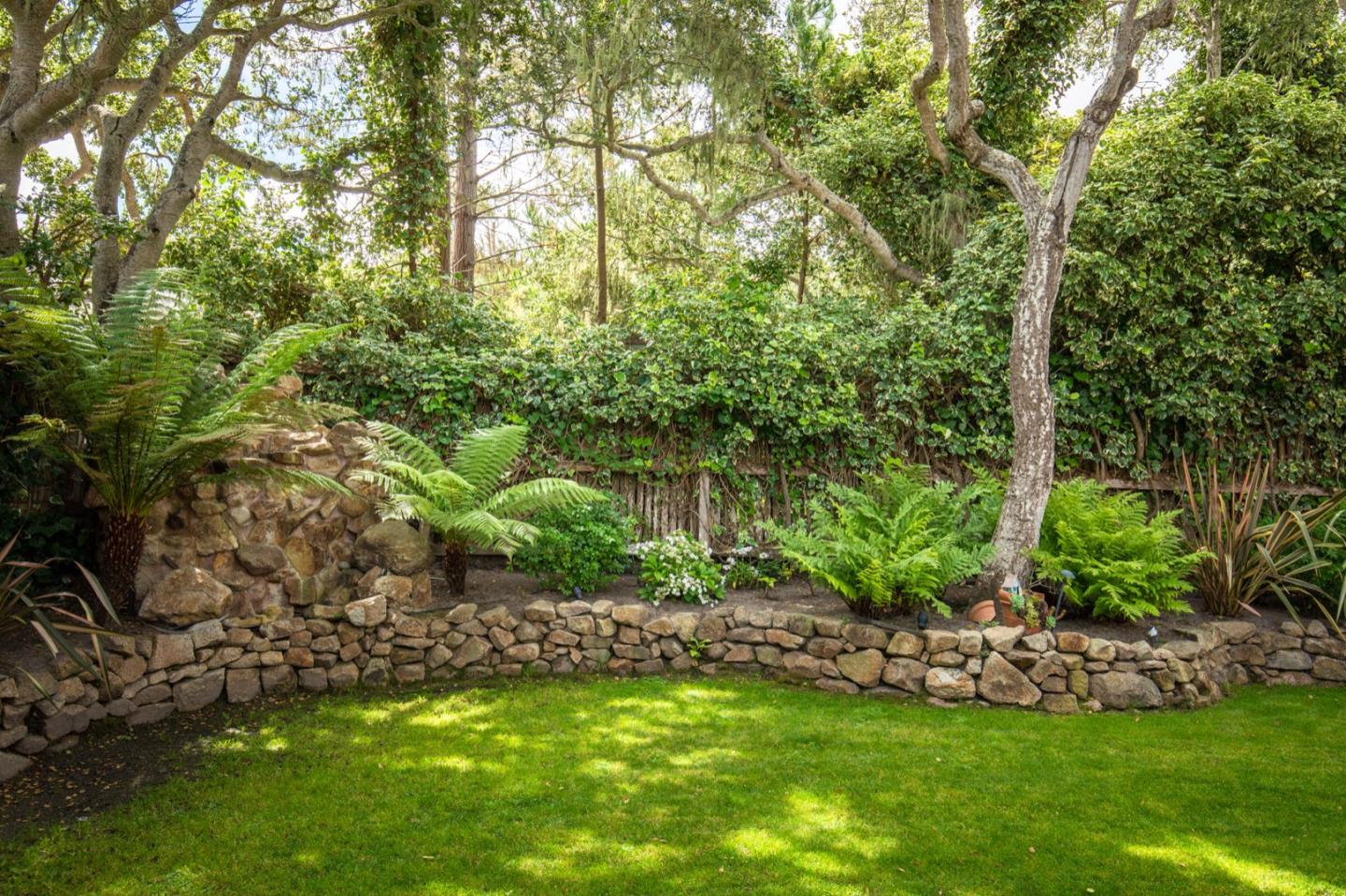 2869 Coyote Road Pebble Beach, CA 93953 - Photo 12 of 35 a view of a garden with a bench