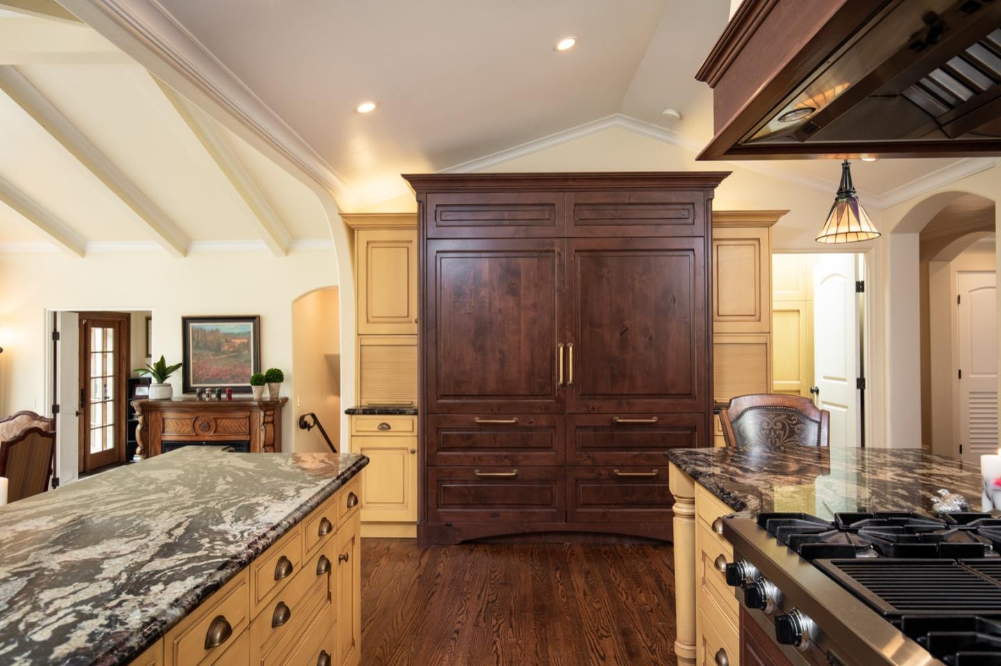 2869 Coyote Road Pebble Beach, CA 93953 - Photo 19 of 35 a kitchen with a stove and a wooden floor