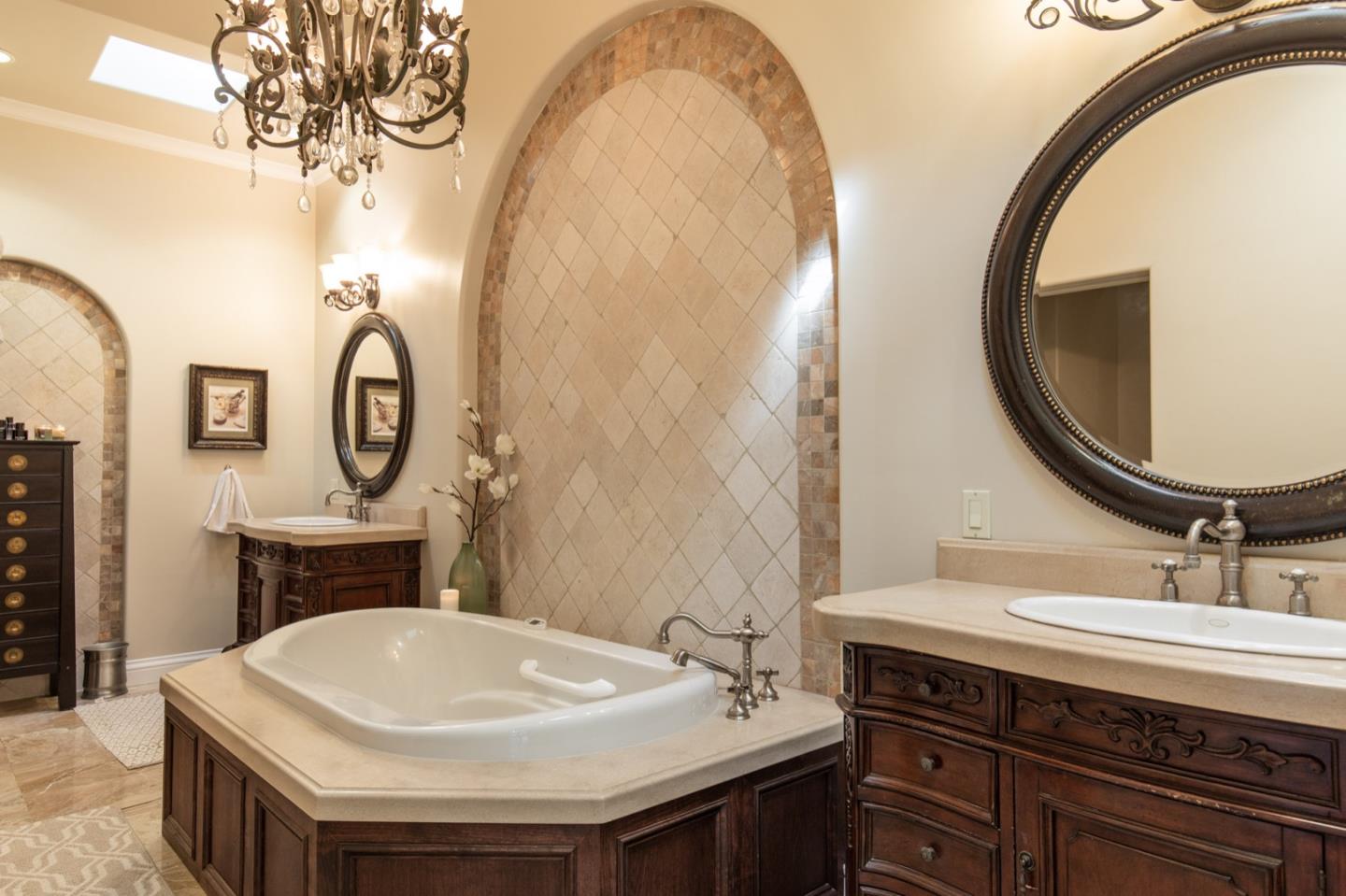 2869 Coyote Road Pebble Beach, CA 93953 - Photo 26 of 35 a bathroom with a sink a mirror and a toilet