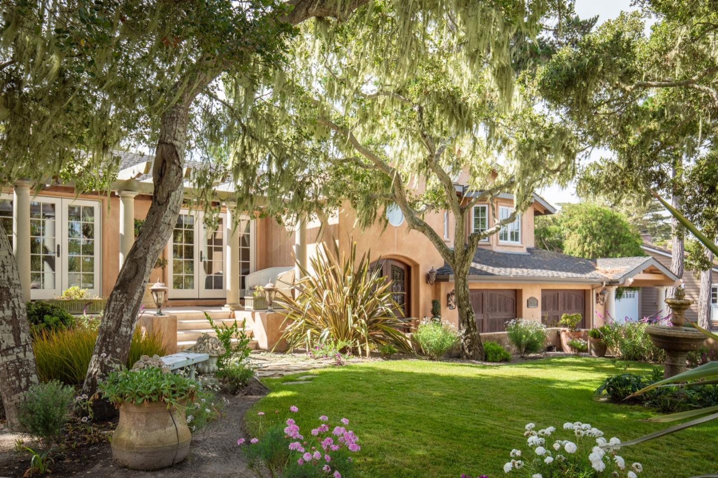 2869 Coyote Road Pebble Beach, CA 93953 - Photo 3 of 35 a front view of a house with a garden