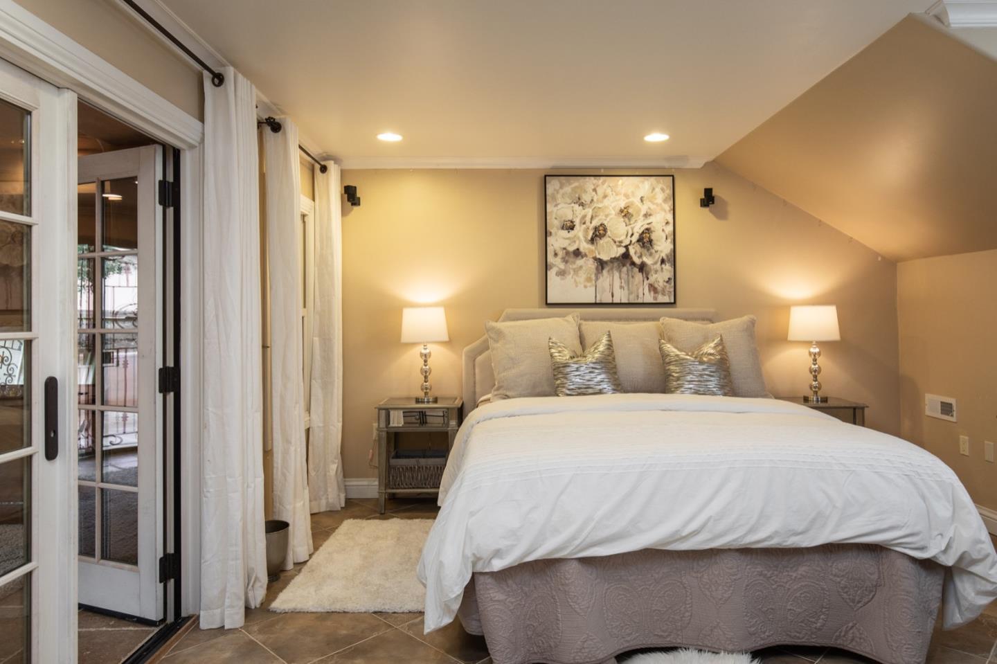 2869 Coyote Road Pebble Beach, CA 93953 - Photo 32 of 35 a bedroom with a large bed and a painting on the wall