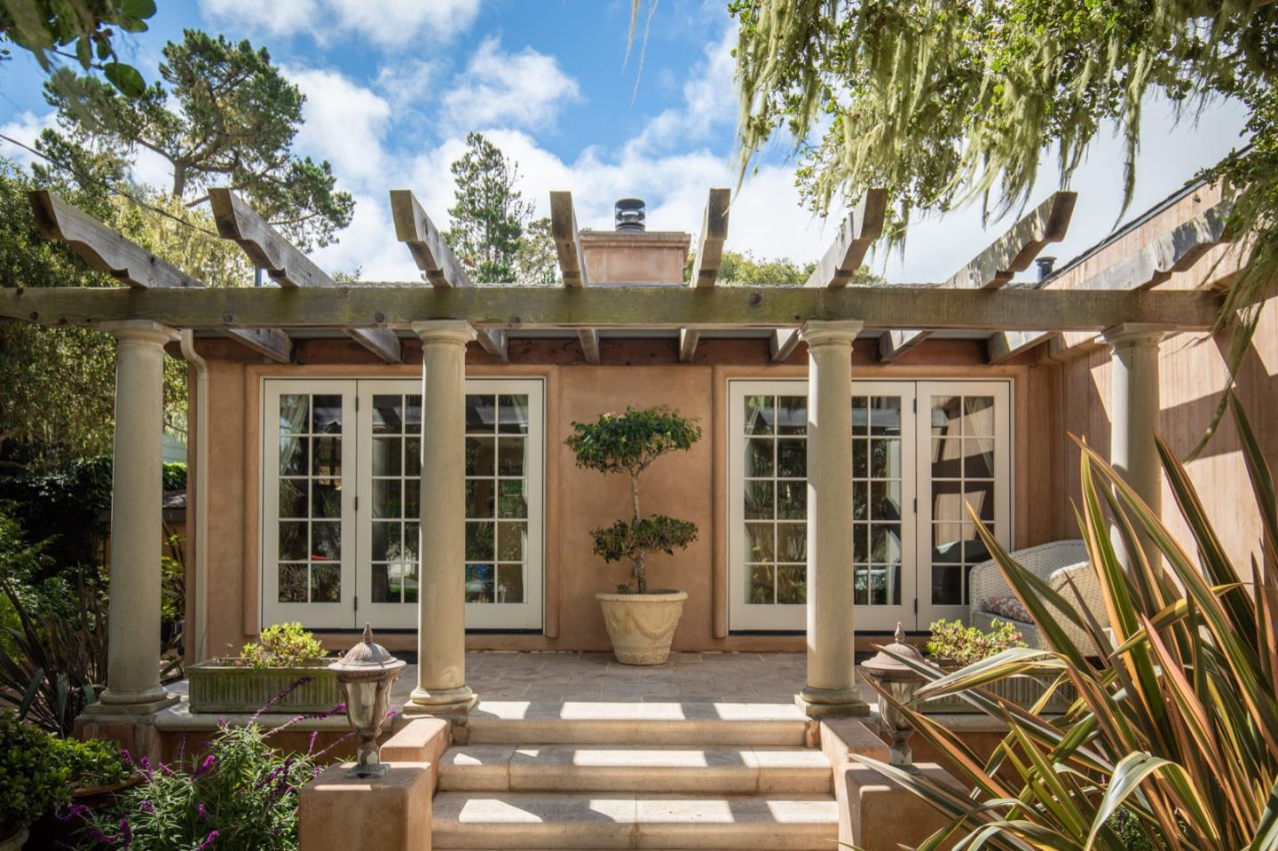 2869 Coyote Road Pebble Beach, CA 93953 - Photo 6 of 35 a front view of a building with glass windows and door