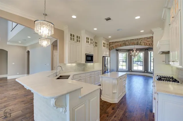 a view of a kitchen area kitchen island and living room