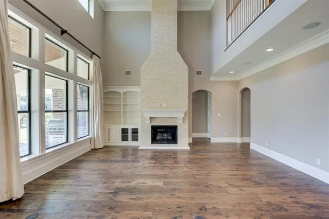 a view of a livingroom with a fireplace and window
