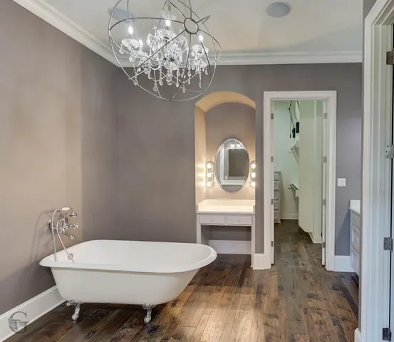 a workspace with wooden floor and a chandelier