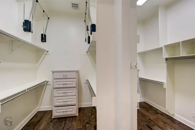 a view of a room with wooden floor and chandelier