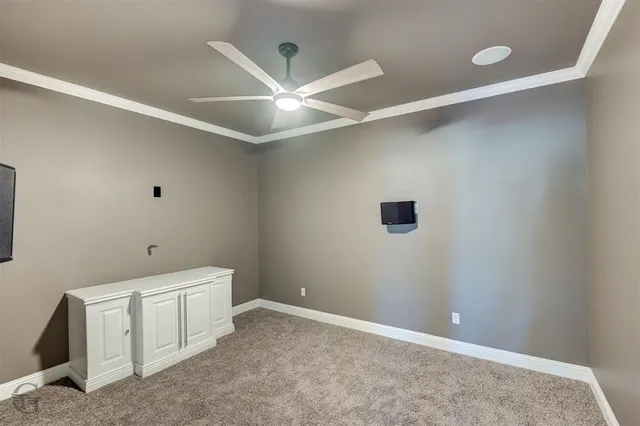 an empty room with a ceiling fan and a window