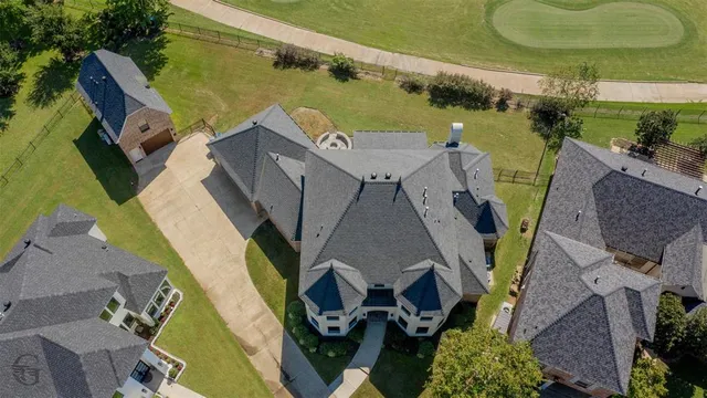 an aerial view of a house with outdoor space and a lake view