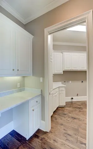 a kitchen with white cabinets and sink