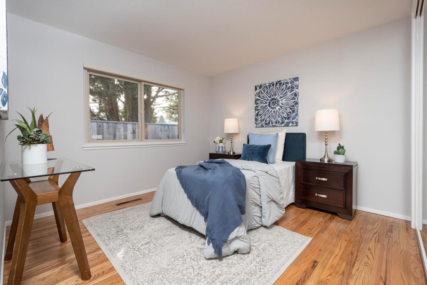 3115 Rivera Drive Burlingame, CA 94010 - Photo 21 of 26 a bedroom with a bed and wooden floor