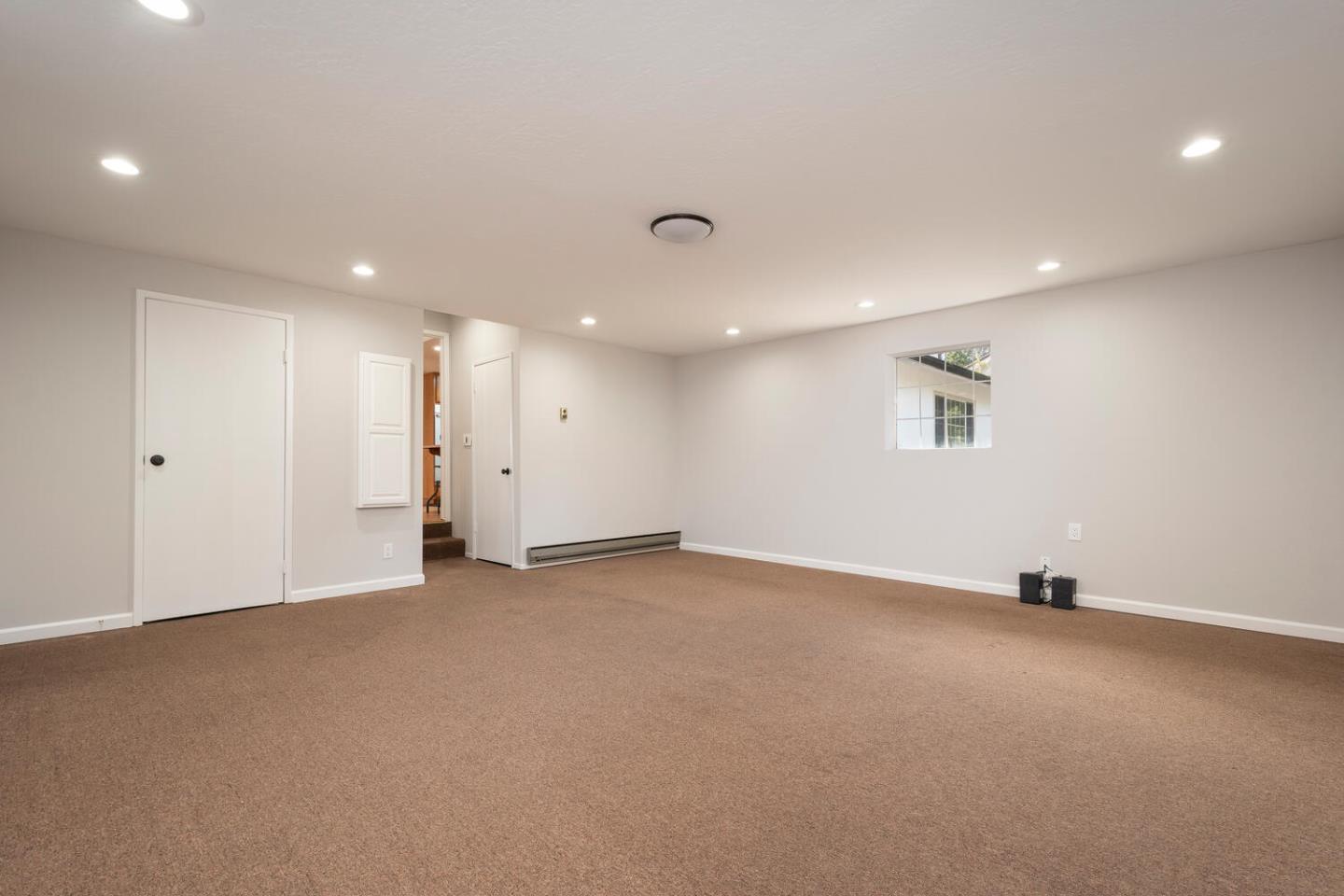 3115 Rivera Drive Burlingame, CA 94010 - Photo 23 of 26 an empty room with a projector and windows