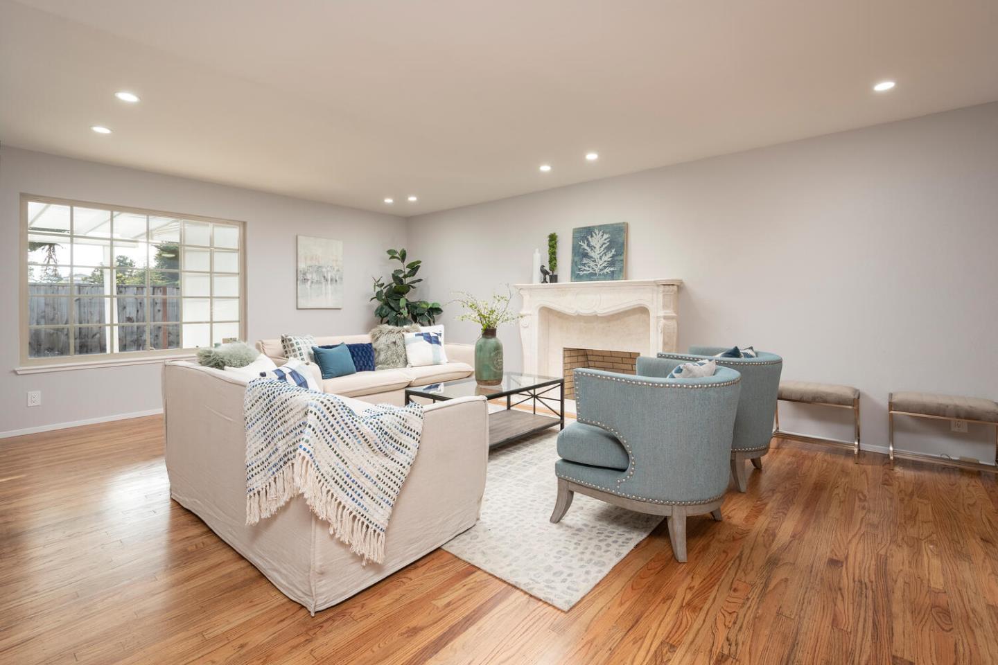 3115 Rivera Drive Burlingame, CA 94010 - Photo 6 of 26 a living room with furniture a large window and wooden floor