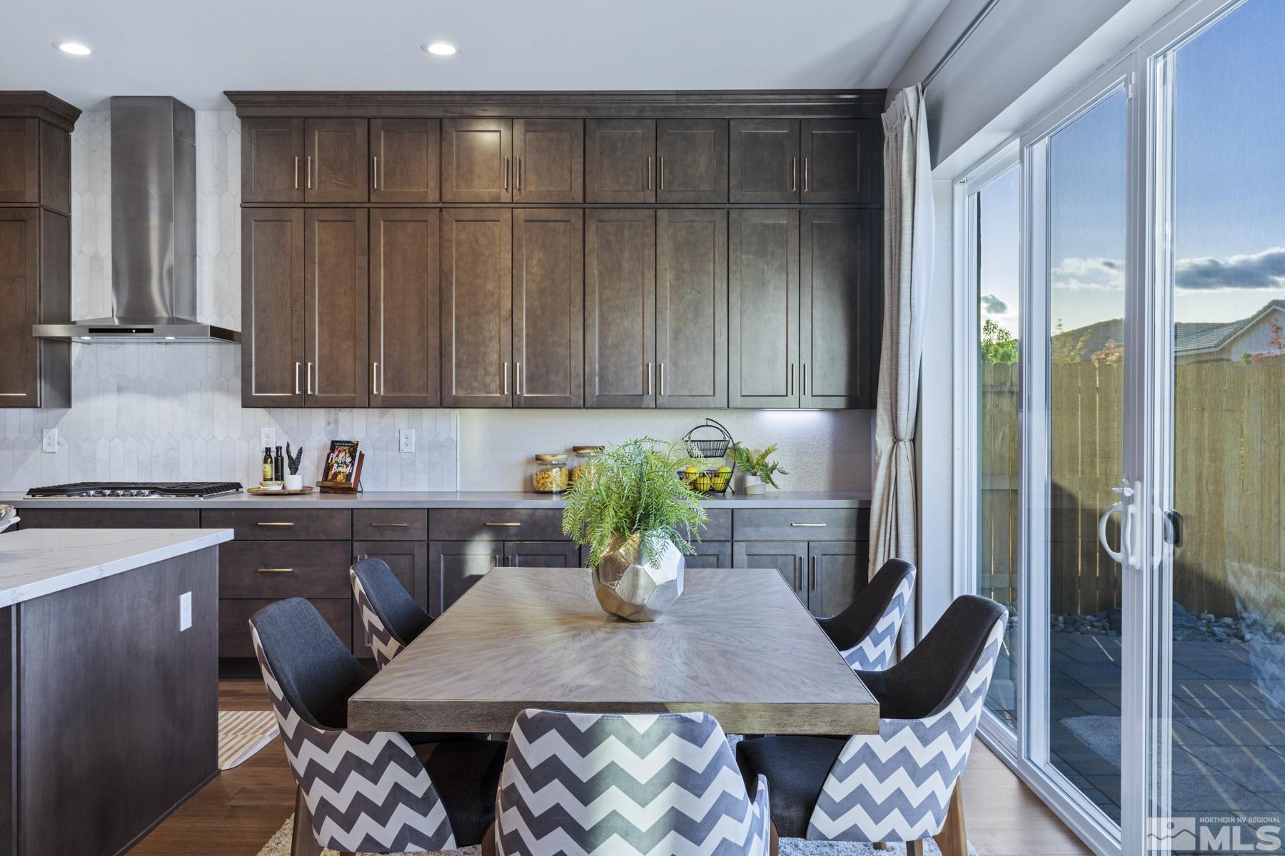 2329 Blushing Rock Drive Reno, NV 89521 - Photo 13 of 40 a kitchen with a table chairs refrigerator and cabinets
