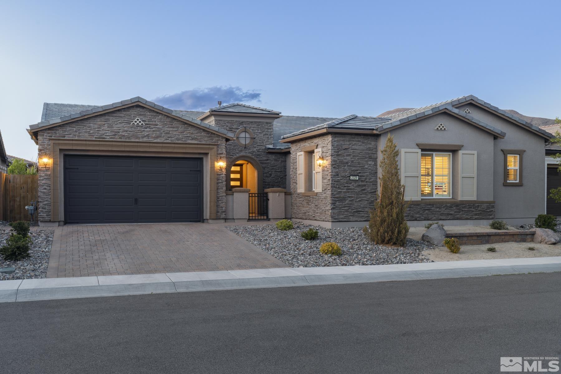 2329 Blushing Rock Drive Reno, NV 89521 - Photo 2 of 40 a front view of a house with a yard and garage