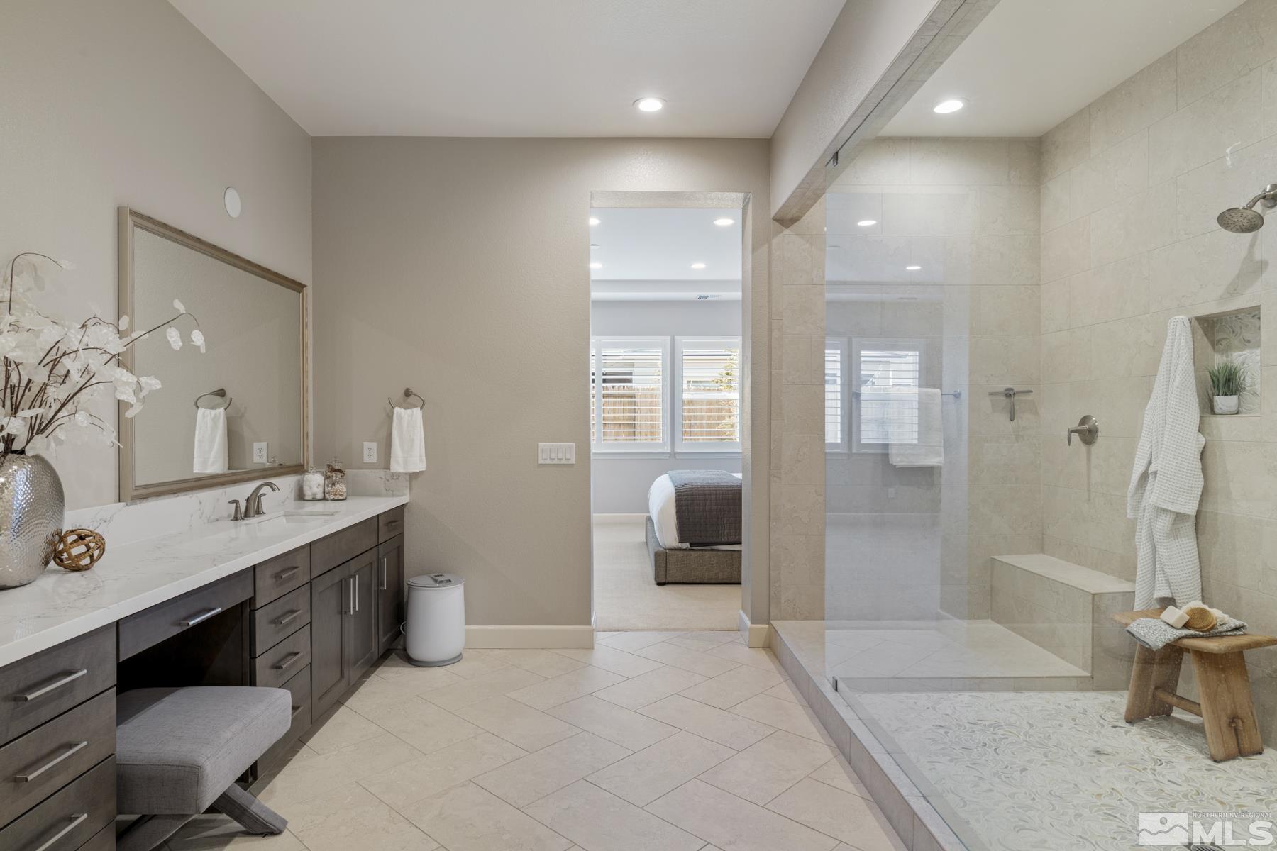 2329 Blushing Rock Drive Reno, NV 89521 - Photo 22 of 40 a bathroom with a double vanity sink toilet and shower