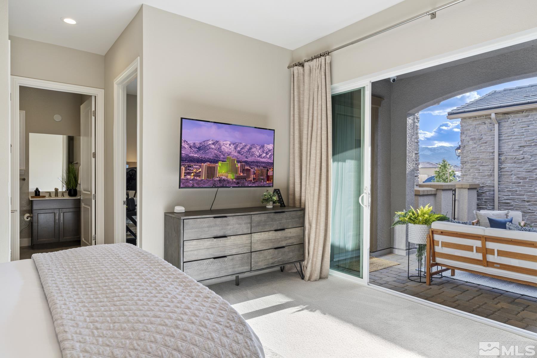 2329 Blushing Rock Drive Reno, NV 89521 - Photo 26 of 40 a bedroom with furniture and a flat screen tv