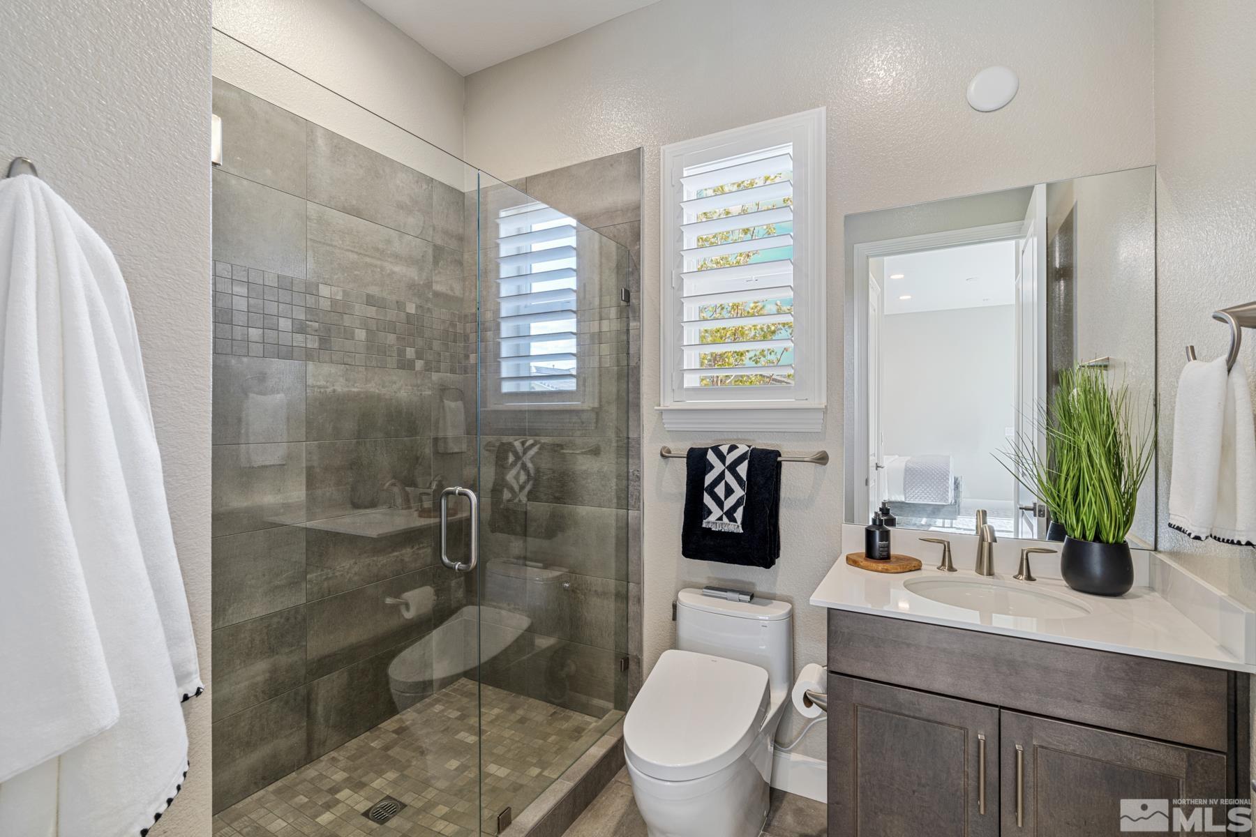 2329 Blushing Rock Drive Reno, NV 89521 - Photo 29 of 40 a bathroom with a sink a toilet and shower