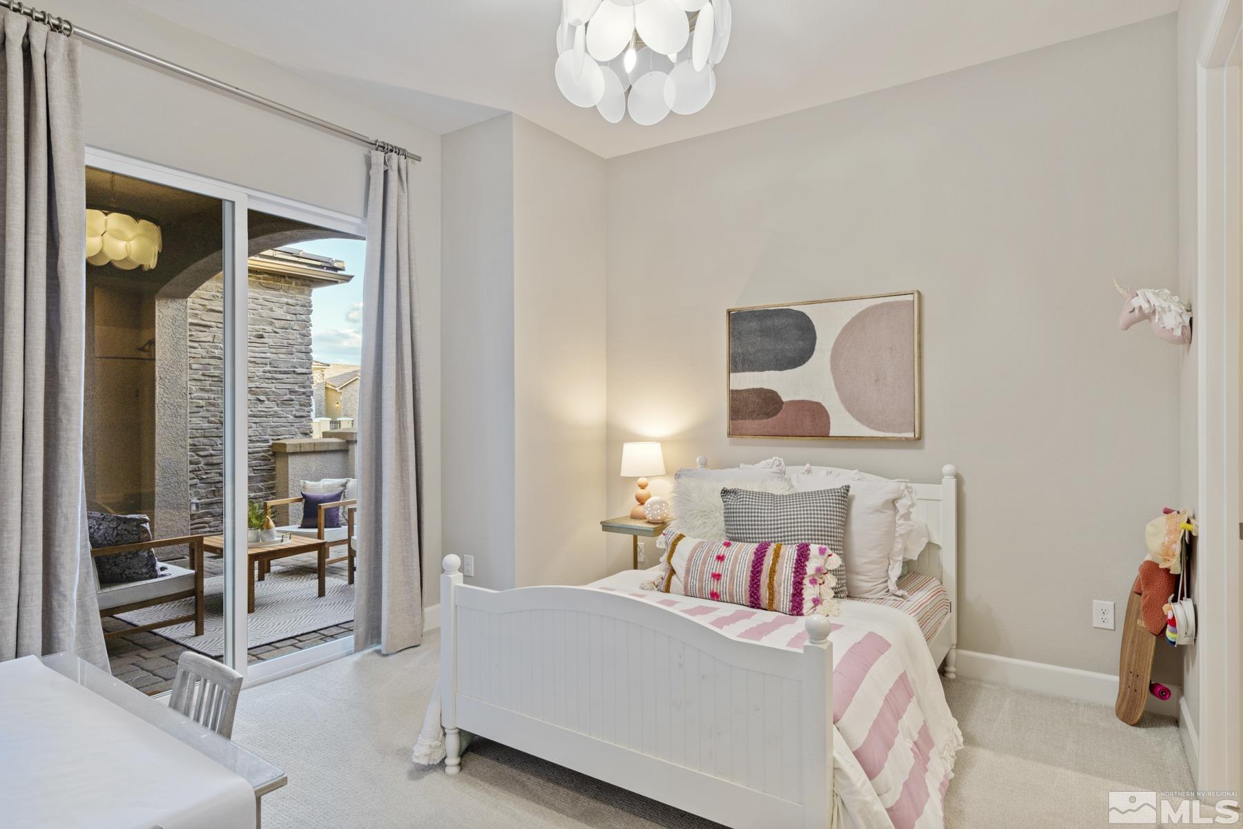 2329 Blushing Rock Drive Reno, NV 89521 - Photo 30 of 40 a bedroom with a bed and a chandelier