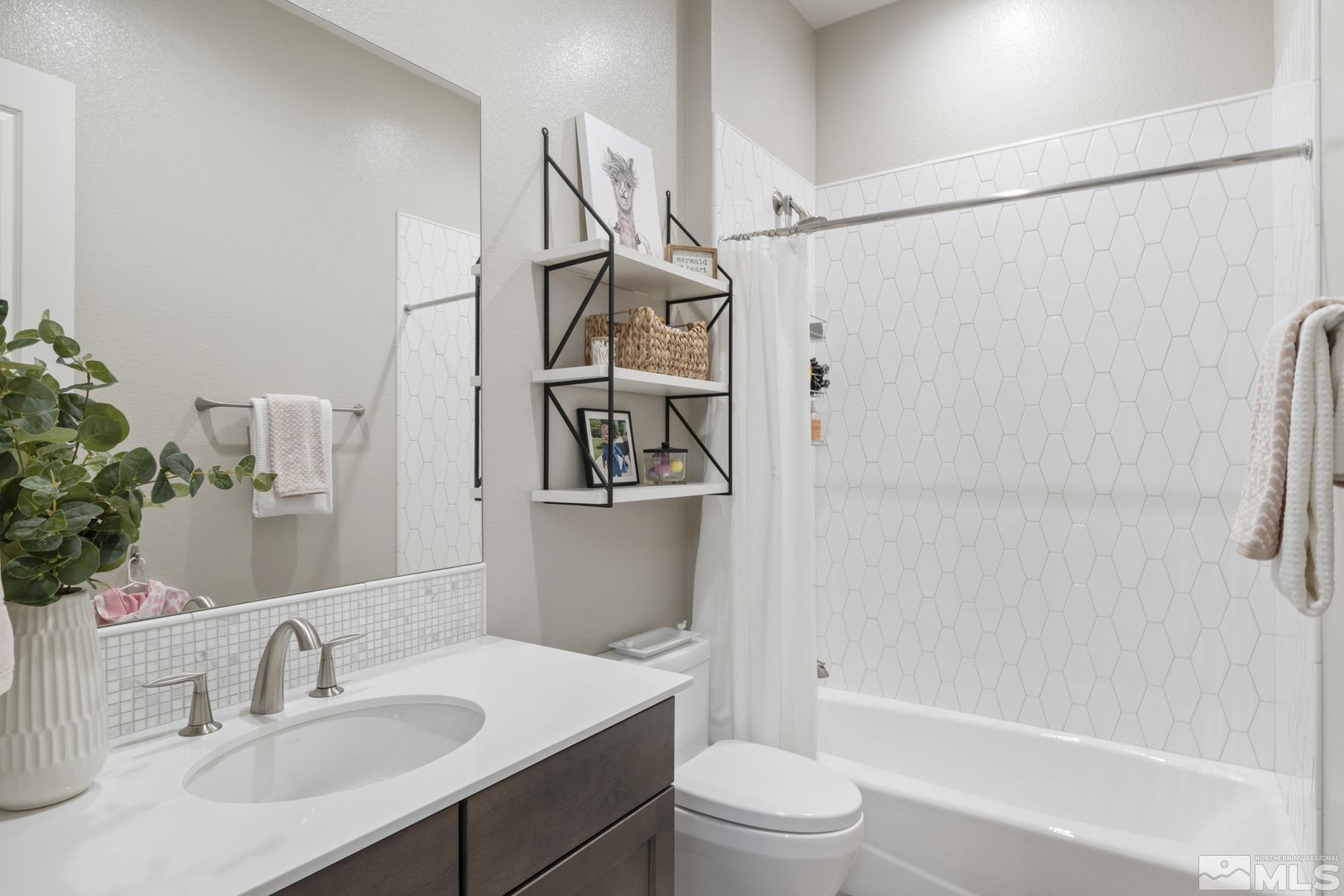 2329 Blushing Rock Drive Reno, NV 89521 - Photo 31 of 40 a bathroom with a sink a toilet and shower