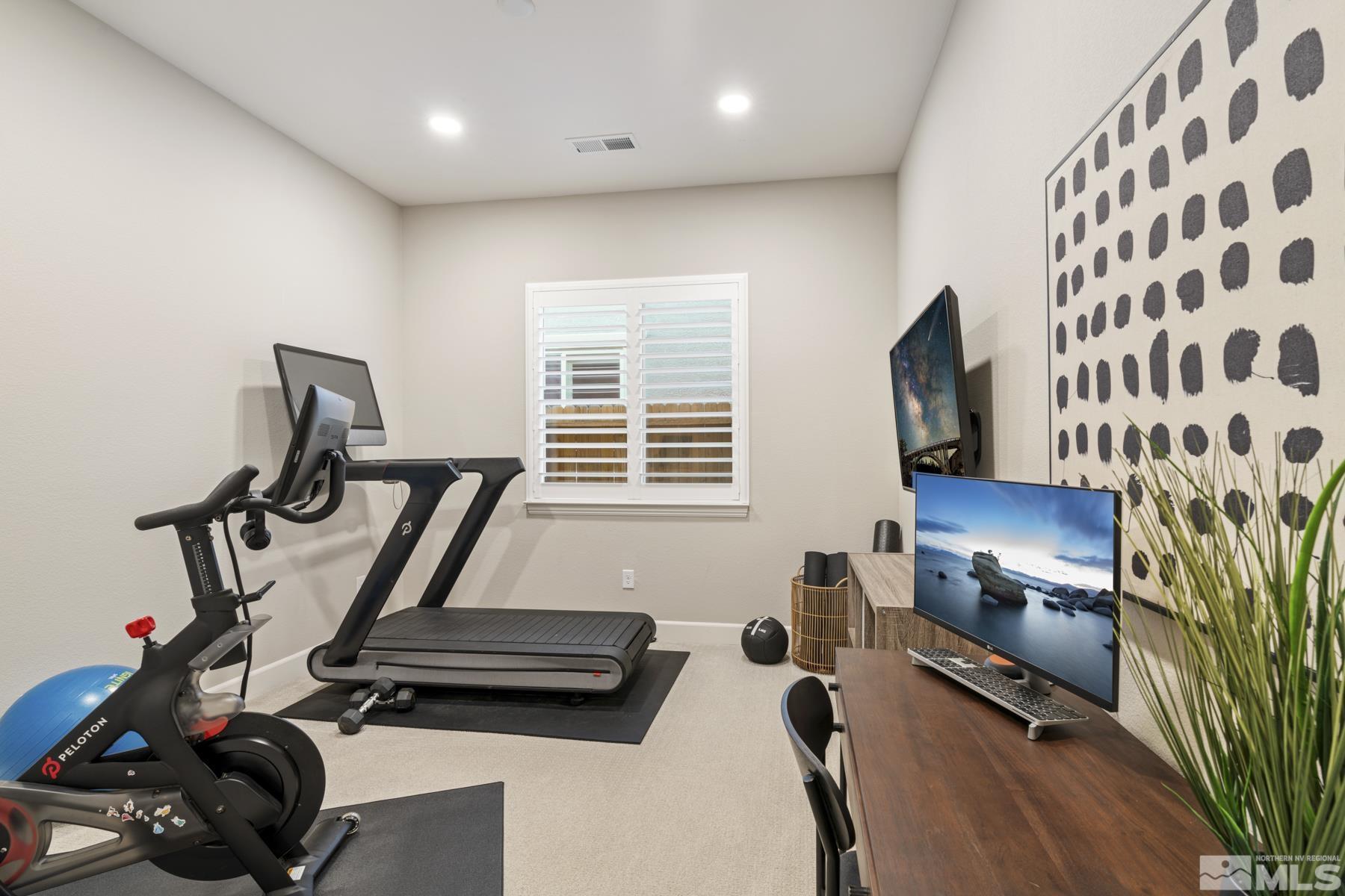 2329 Blushing Rock Drive Reno, NV 89521 - Photo 32 of 40 a room with gym equipment and a flat screen tv