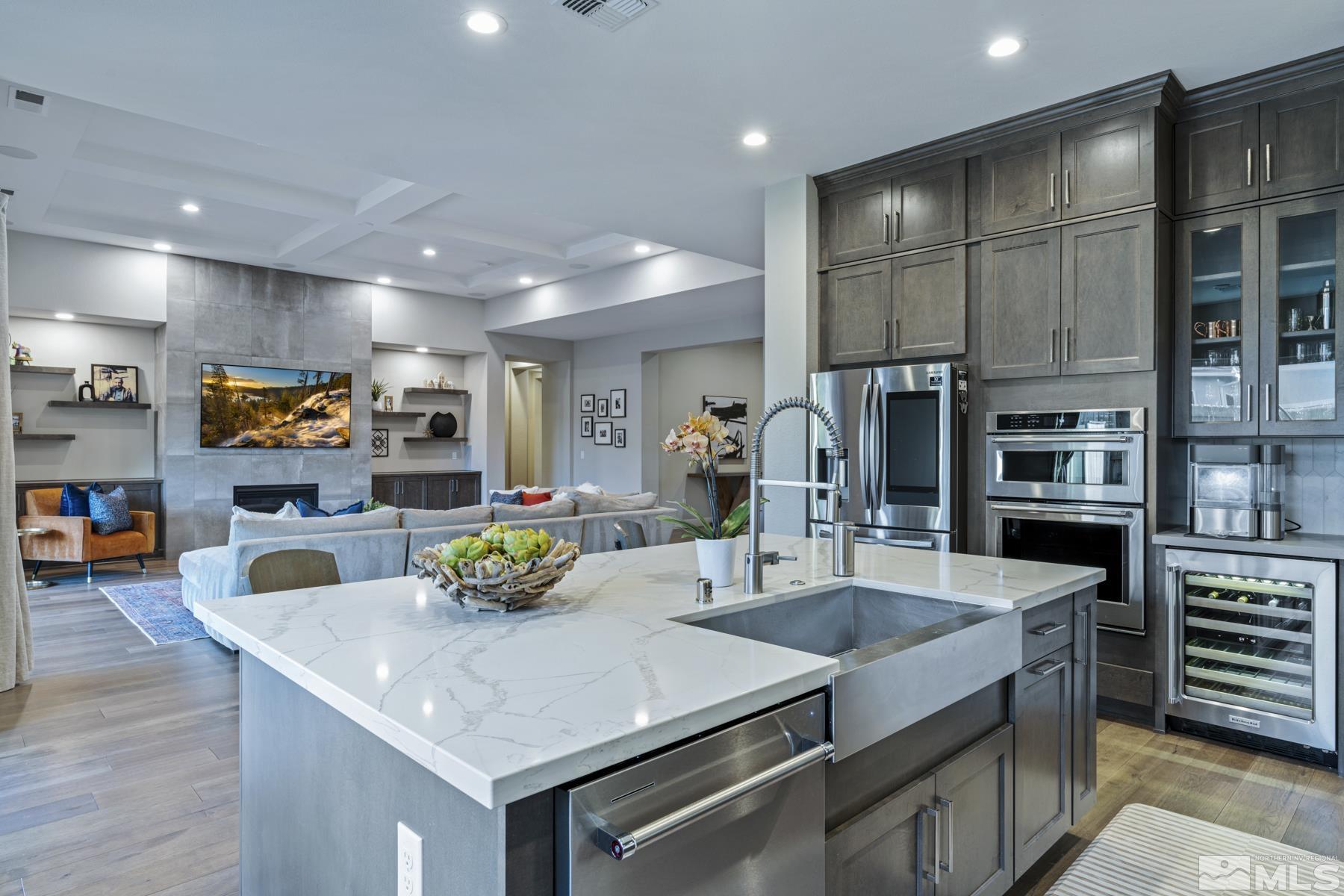 2329 Blushing Rock Drive Reno, NV 89521 - Photo 8 of 40 a kitchen with stainless steel appliances granite countertop a sink a stove and a wooden floors