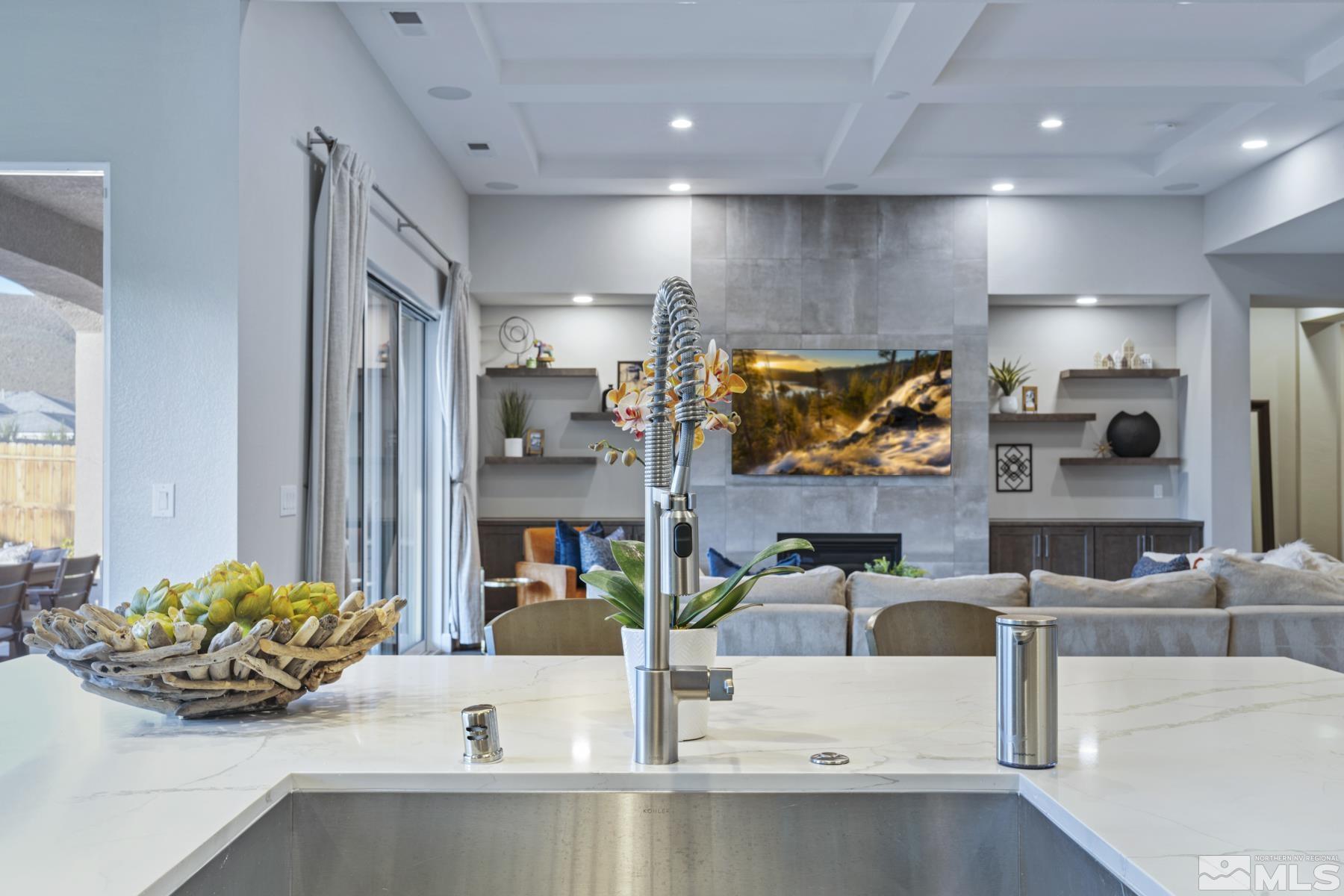 2329 Blushing Rock Drive Reno, NV 89521 - Photo 9 of 40 a kitchen with stainless steel appliances kitchen island granite countertop a sink and a white cabinets