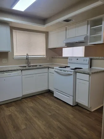 a kitchen with stainless steel appliances granite countertop a sink stove and cabinets