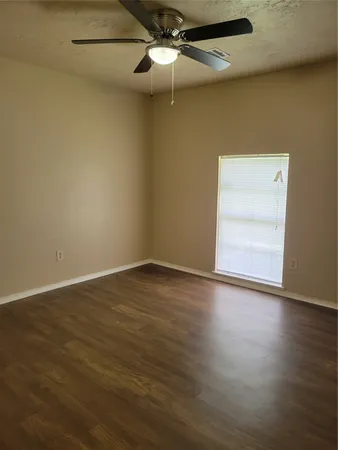 a bathroom with a granite countertop toilet and a sink