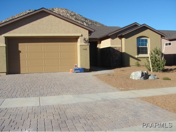 1168 Rusty Nail Road Prescott Valley, AZ 86314 - Photo 1 of 5 a front view of a house with a yard