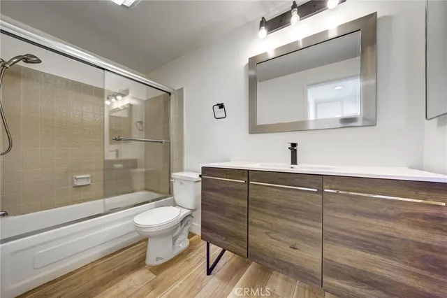 a bathroom with a toilet a sink and glass door