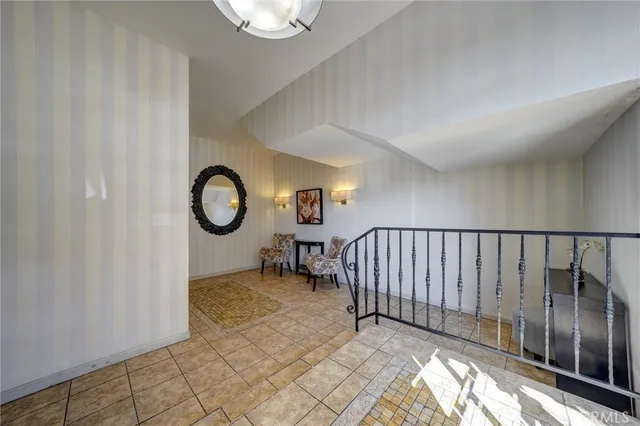 a view of a hallway with entryway wooden floor and door