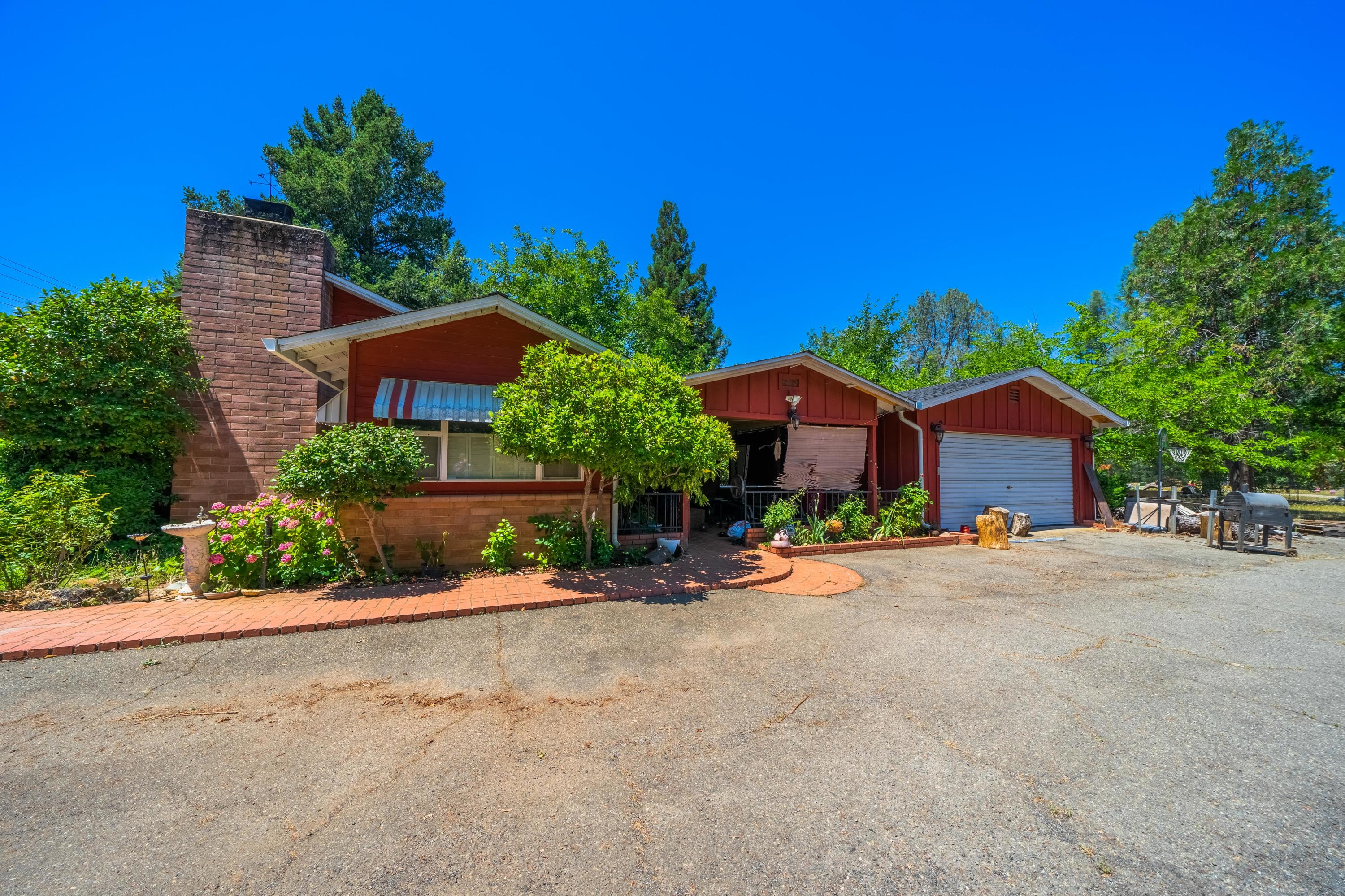 a front view of a house with a yard and a garage
