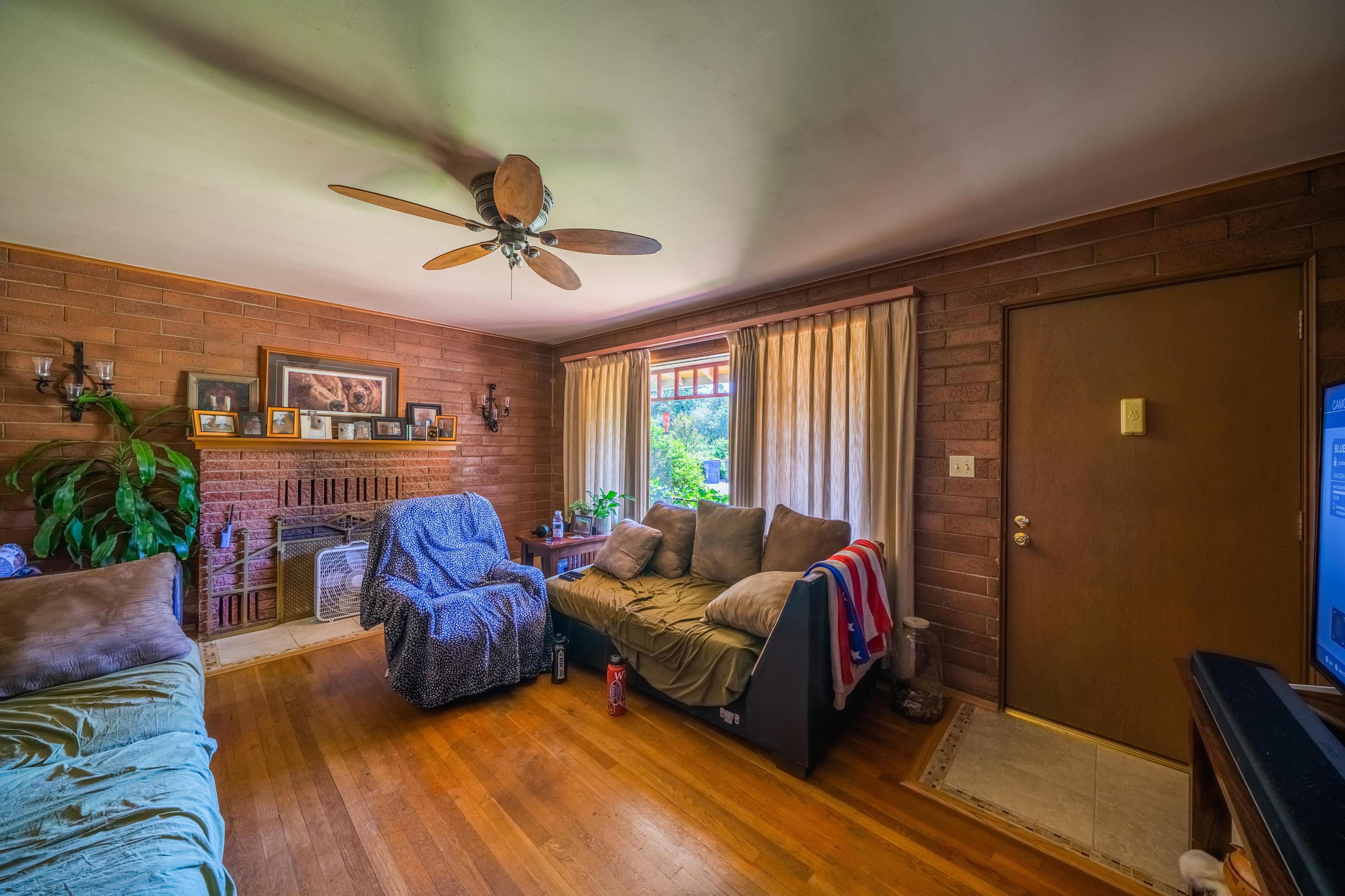 1542 Old Alturas Road Redding, CA 96003 - Photo 11 of 20 a living room with furniture a ceiling fan and a window