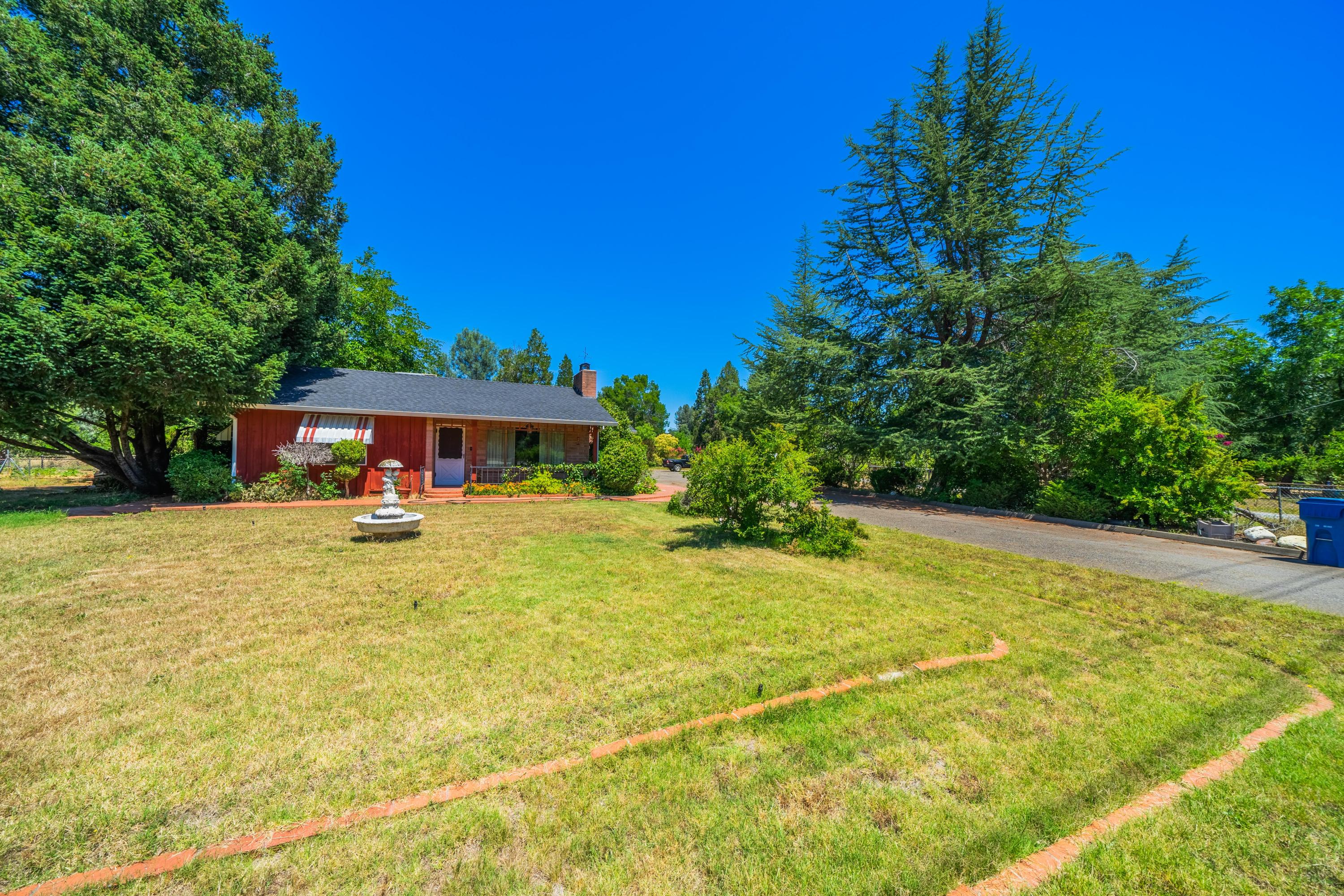 1542 Old Alturas Road Redding, CA 96003 - Photo 14 of 20 a front view of a house with yard and swimming pool