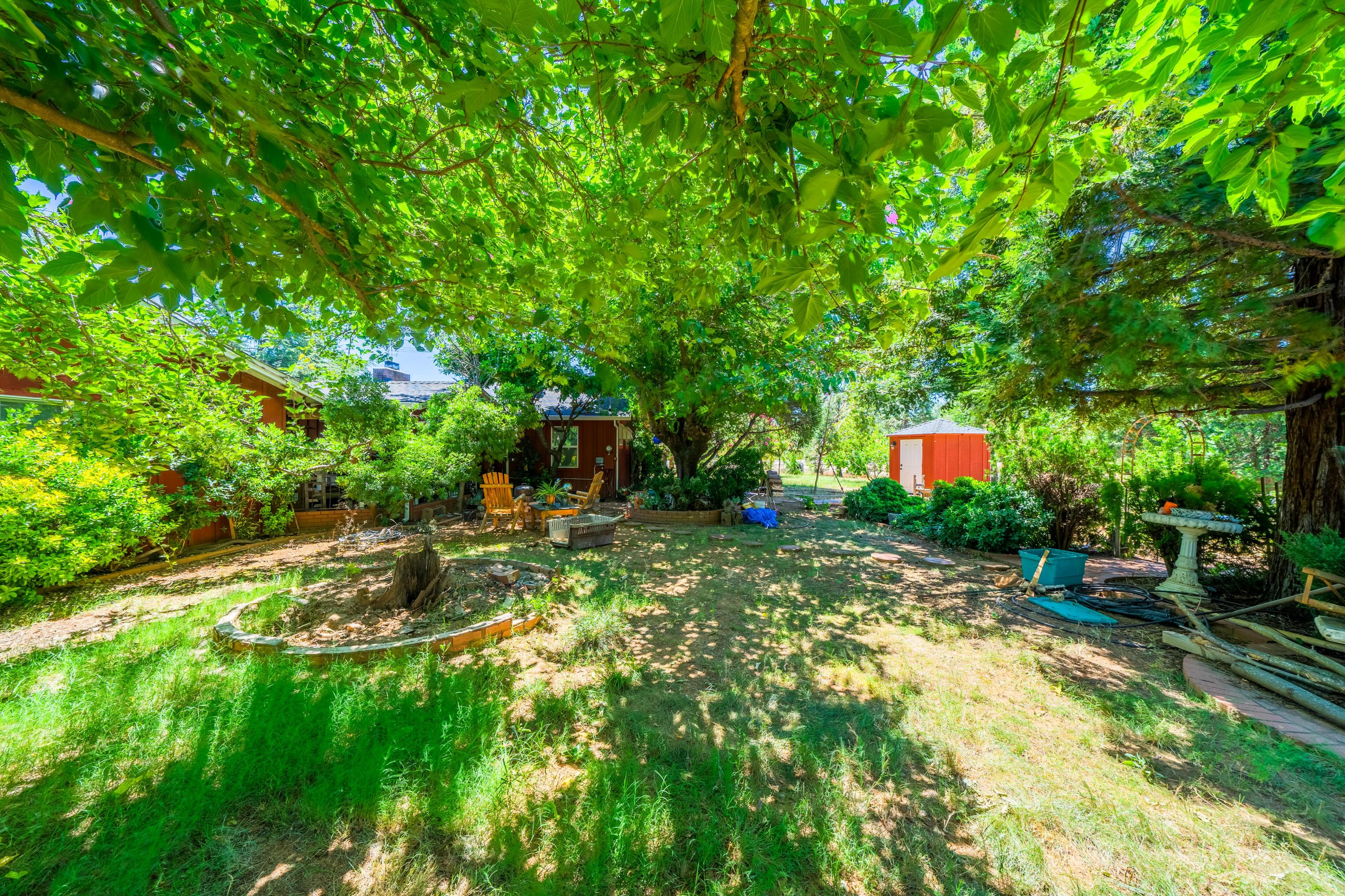 1542 Old Alturas Road Redding, CA 96003 - Photo 5 of 20 a backyard of a house with table and chairs