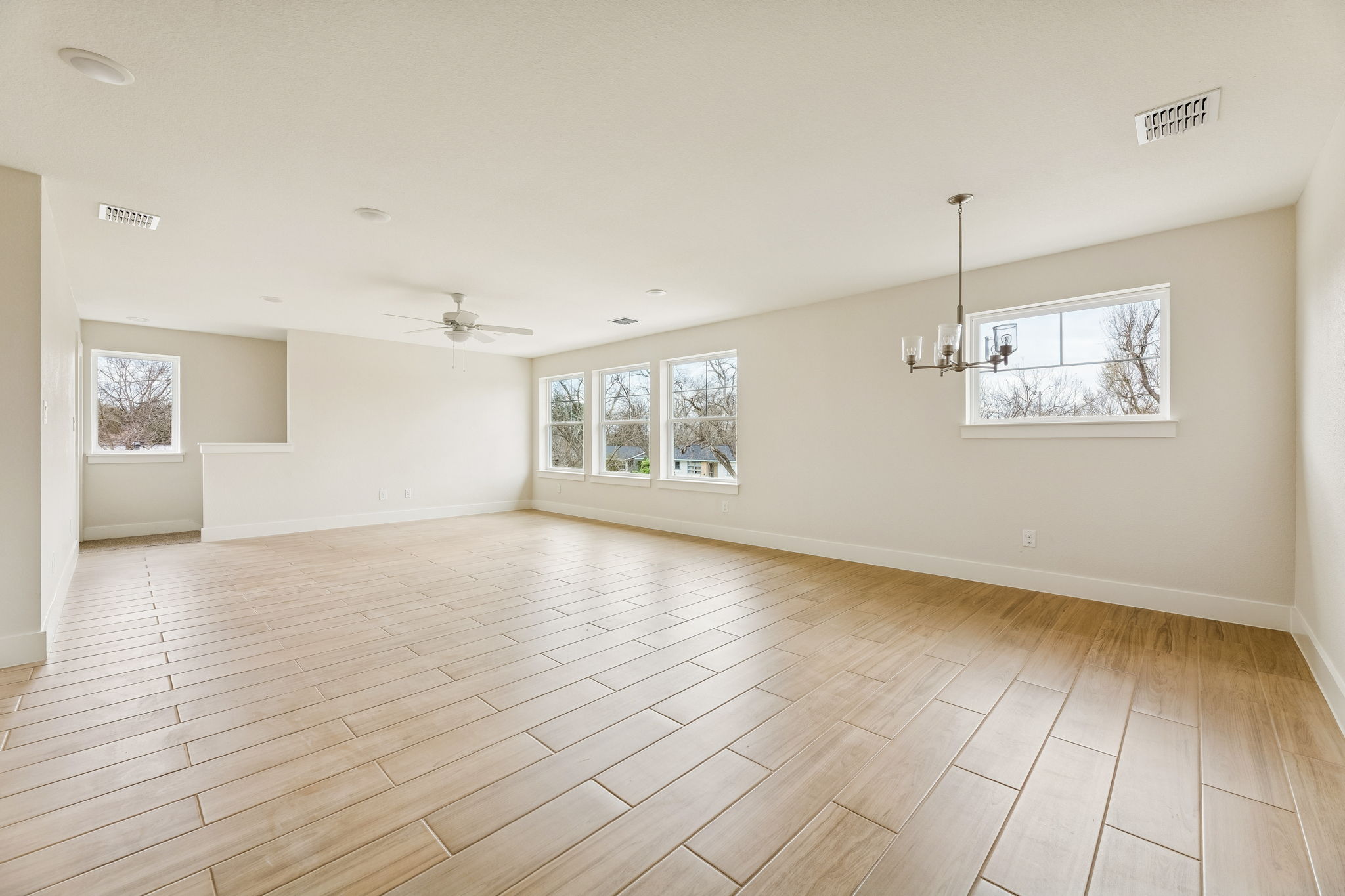 1412 Kent Street Taylor, TX 76574 - Photo 10 of 12 Guest Quarters - view from hallway looking at open space of kitchen, dining, living.