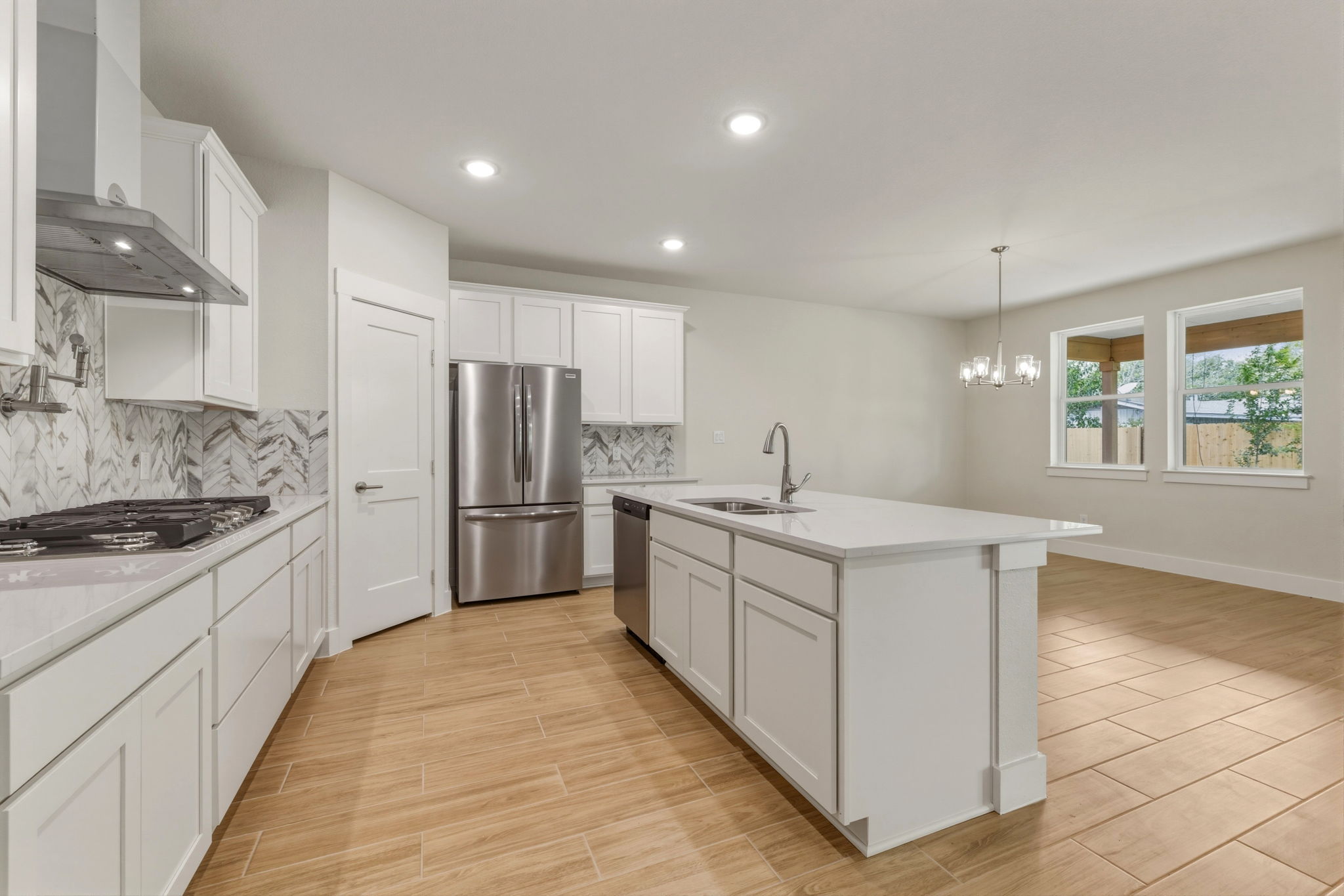 1412 Kent Street Taylor, TX 76574 - Photo 17 of 40 a kitchen with white cabinets and white appliances