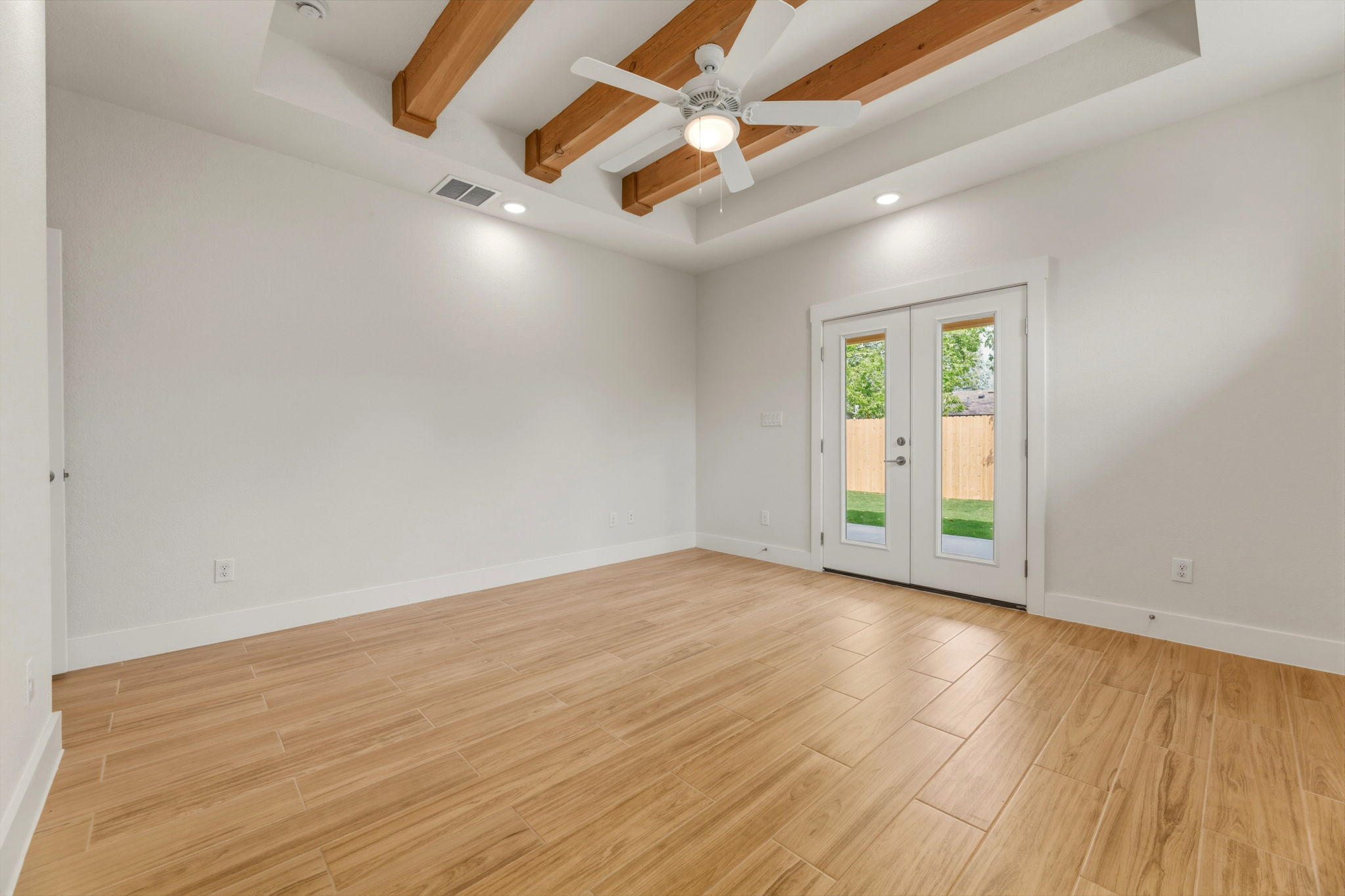 1412 Kent Street Taylor, TX 76574 - Photo 20 of 40 an empty room with wooden floor and windows