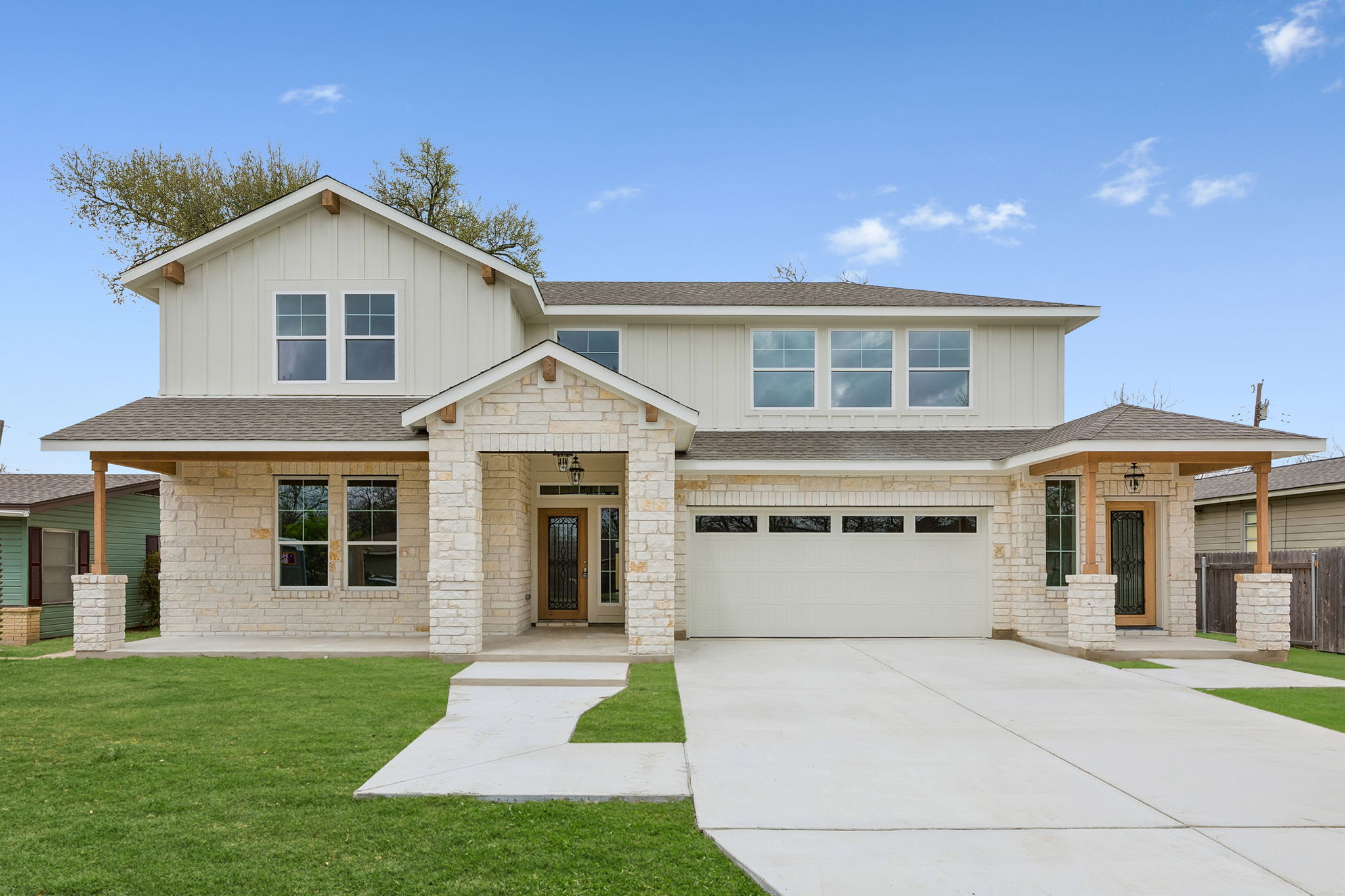 1412 Kent Street Taylor, TX 76574 - Photo 2 of 12 Main entrance to the left of the garage. Private entrance to upstairs guest quarters to the right of garage. Grass digitally enhanced.