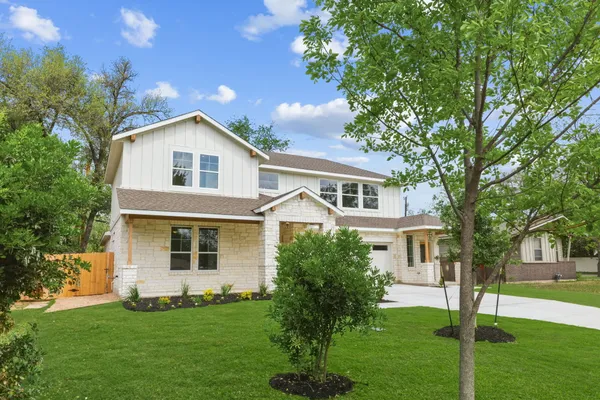 a front view of a house with a garden