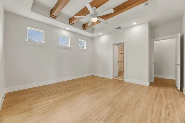a view of an empty room with wooden floor