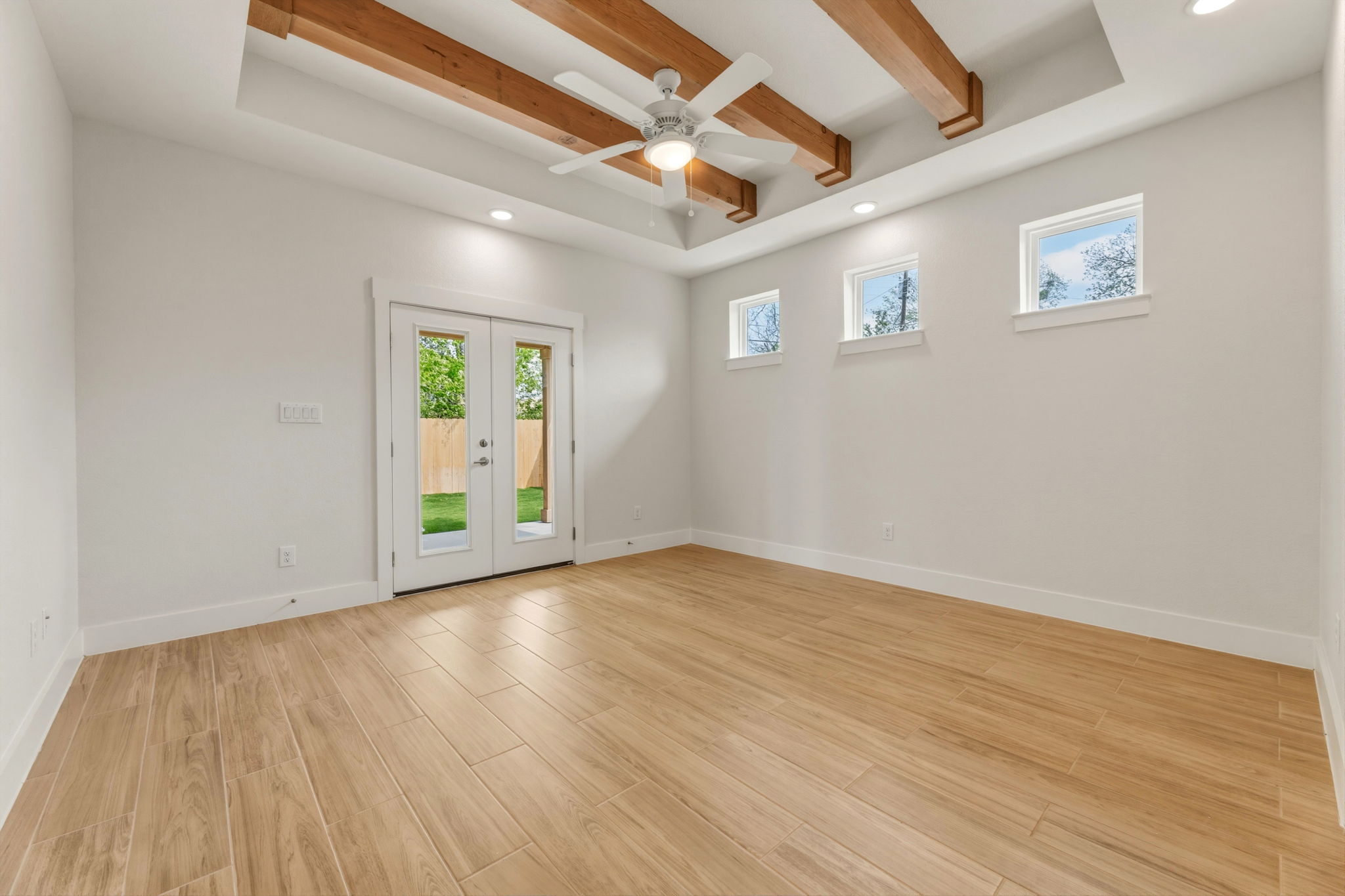 1412 Kent Street Taylor, TX 76574 - Photo 22 of 40 a view of an empty room with wooden floor and a window