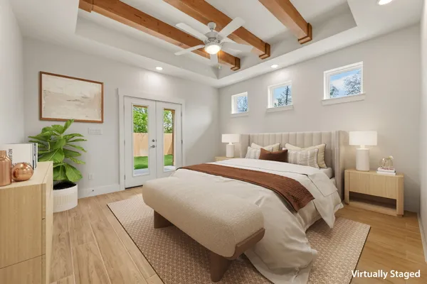 a spacious bedroom with a bed and a potted plant