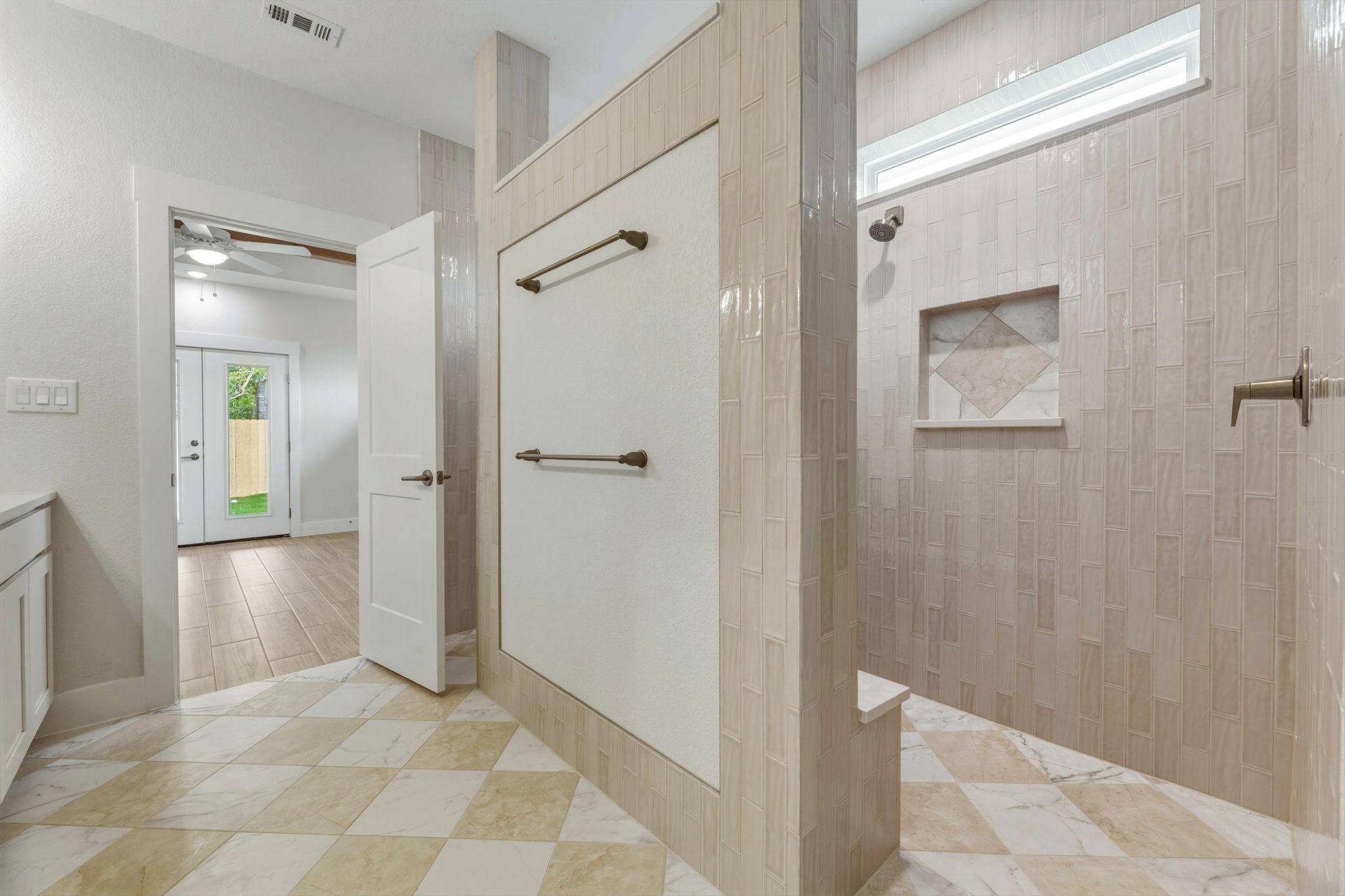1412 Kent Street Taylor, TX 76574 - Photo 26 of 40 a view of a hallway with wooden floor and a bathroom