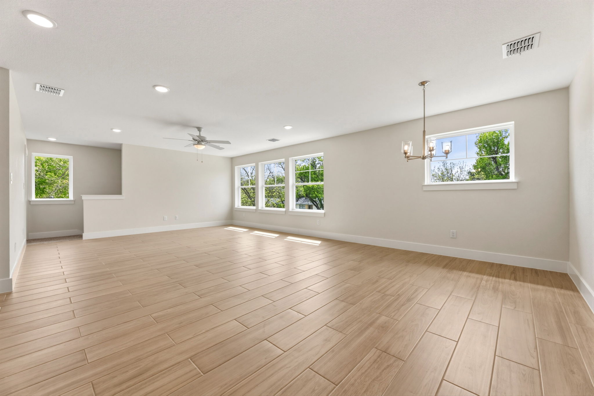 1412 Kent Street Taylor, TX 76574 - Photo 29 of 40 an empty room with wooden floor and windows