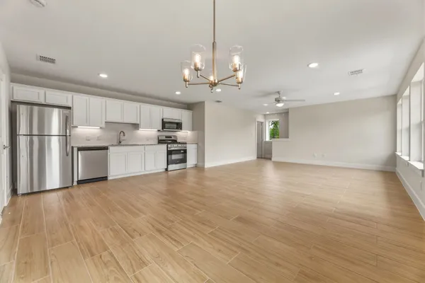 a view of a kitchen with a sink and a refrigerator