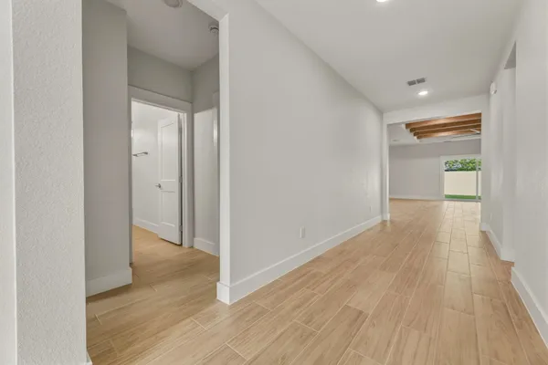 a view of hallway with wooden floor