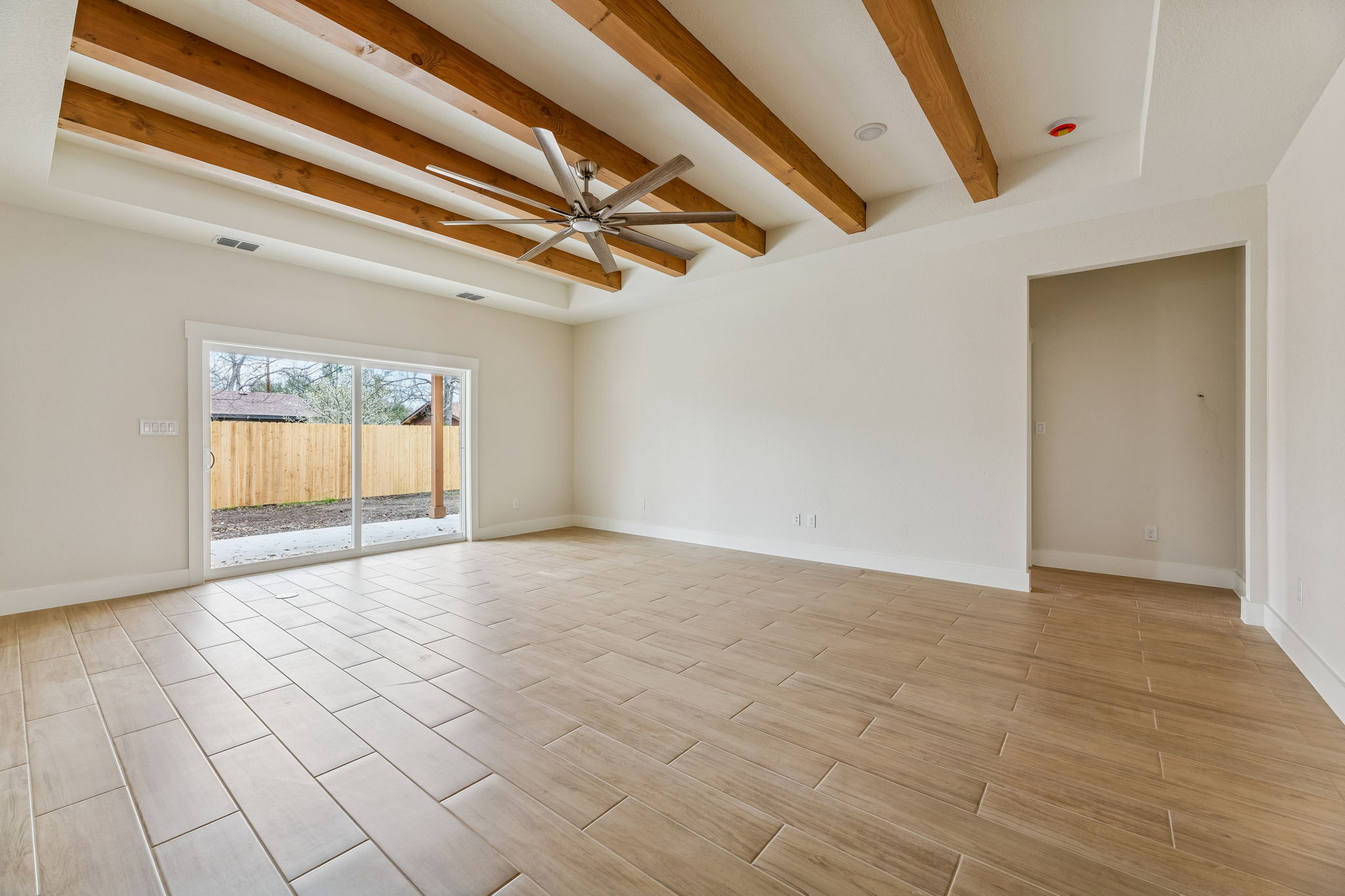 1412 Kent Street Taylor, TX 76574 - Photo 4 of 12 Living room with large sliding glass doors to back covered patio and backyard.